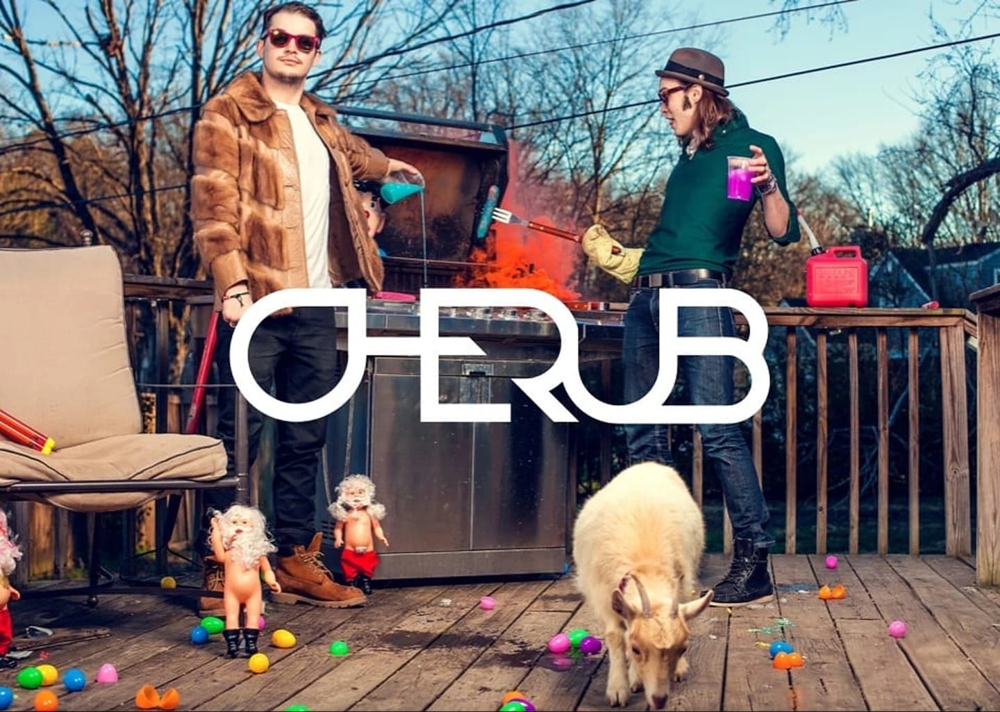 Cherub band photoshoot with the duo on a porch surrounded by toys and a goat.