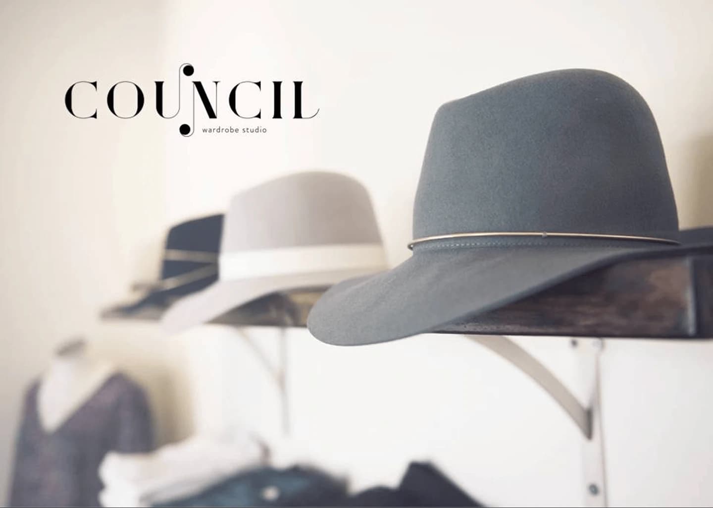 Council Wardrobe Studio brand identity over a softly lit hat display still life.