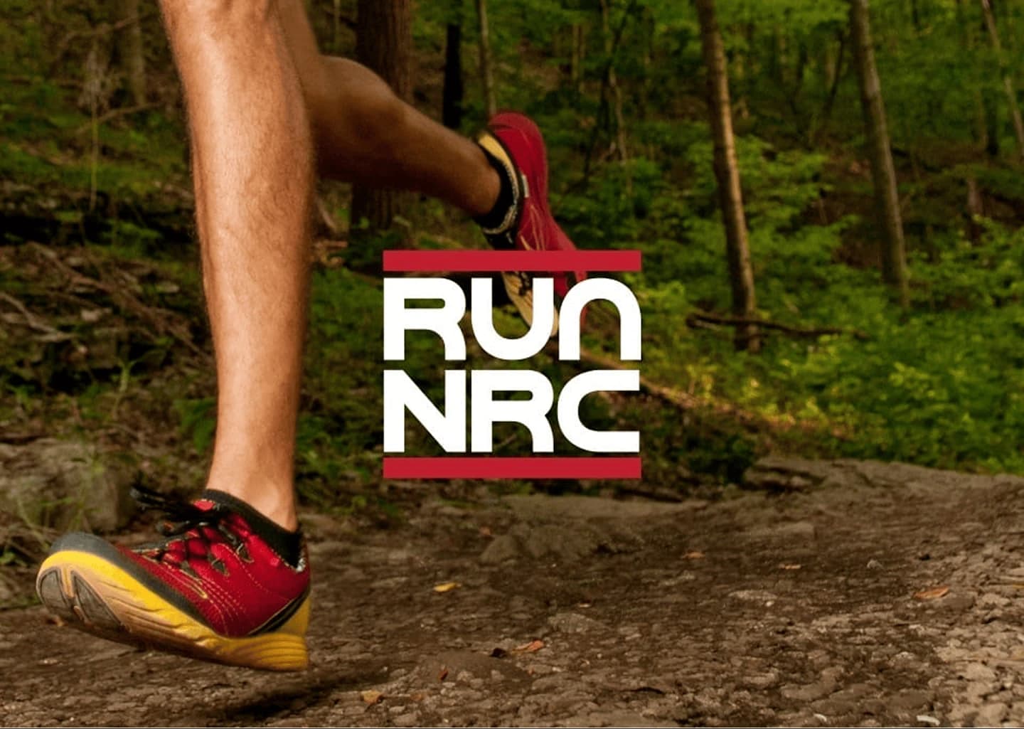 RUN NRC running club brand mark over a trail runner mid-stride on a forest path.