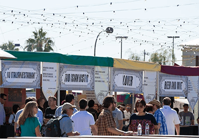 Festival moment from Life is Beautiful with the brand system rendered across stages, walls, and street-level signage.